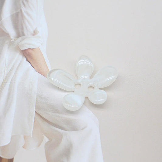 White ombré 5-petal resin sewing button with two holes, flower shape.