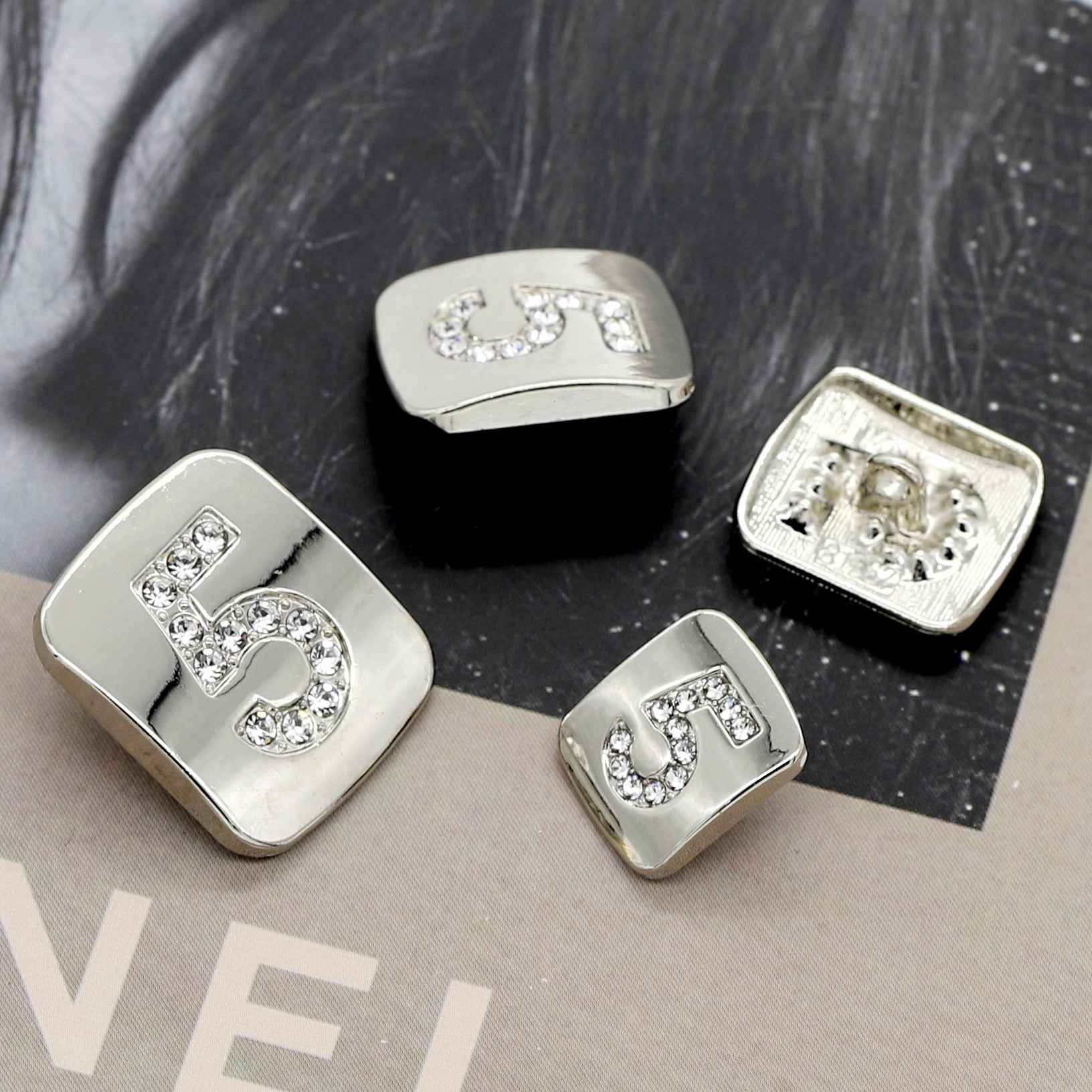 Number 5 shank buttons in silver tone with clear rhinestone decoration