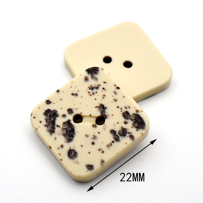Square beige speckled resin button with two-hole front; size 22mm