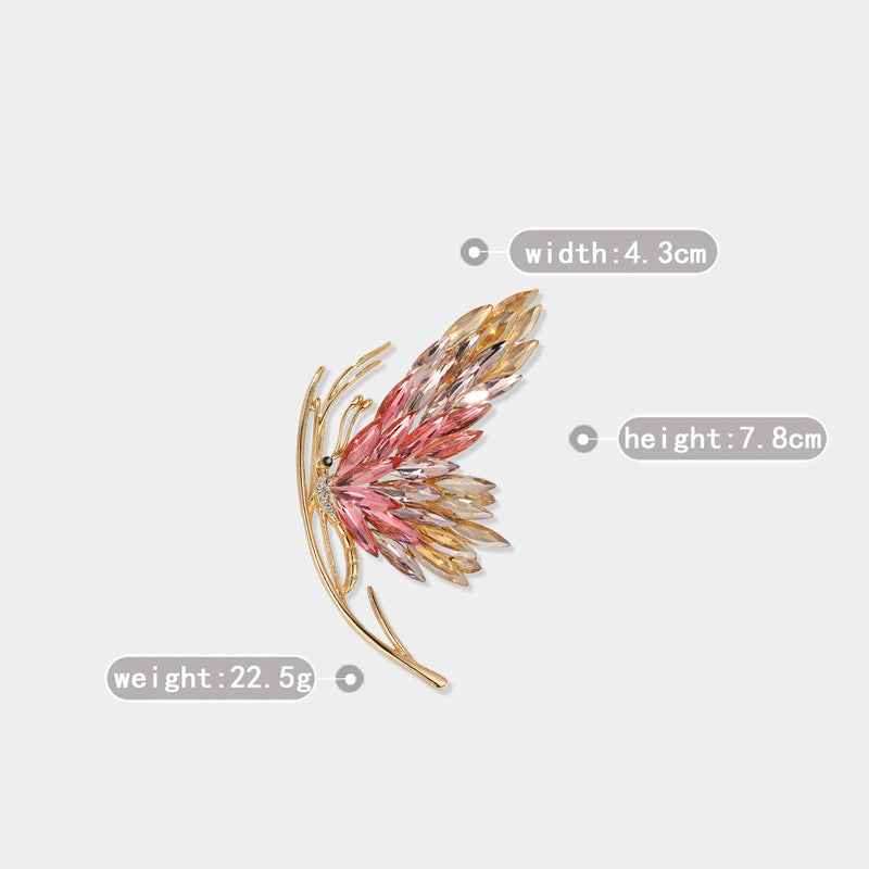 Red and gold-tone crystal butterfly pin with gold-tone needle clasp and faceted wings