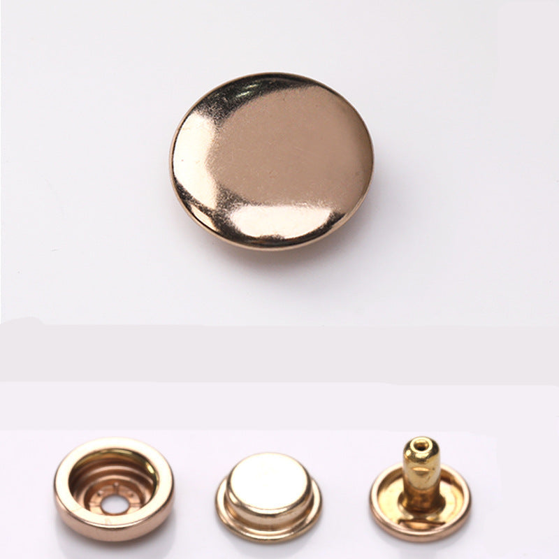 Gold-toned curved metal snap button dome with matching base and post pieces