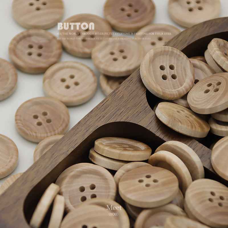 Assorted round natural wood buttons with four holes in light tan