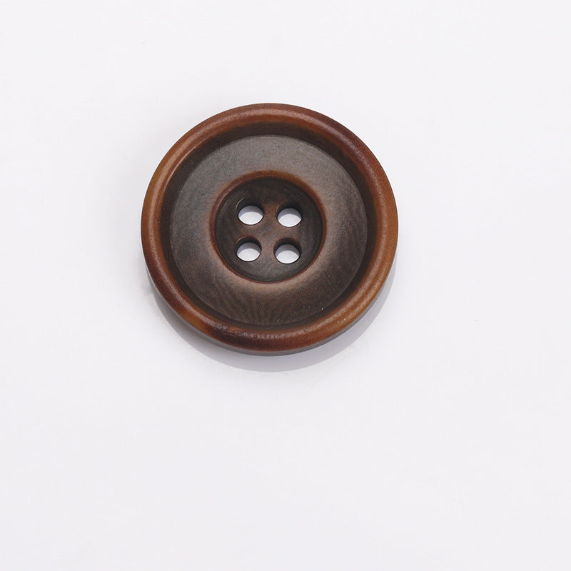 Two-tone round sewing button with dark center and brown outer border, four holes