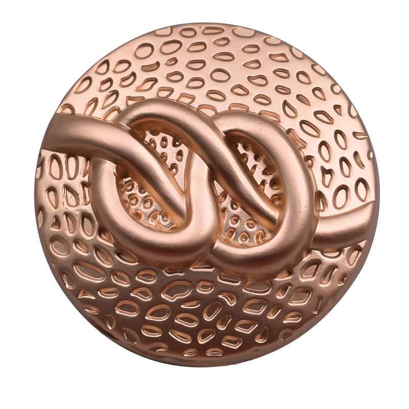 Round antique bronze-tone metal coat button with large swirl and perforated dot texture