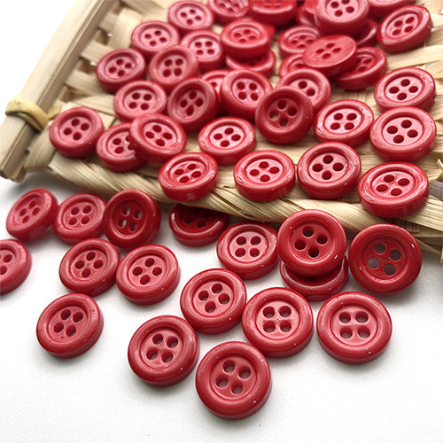 Red 11.5mm round four-hole buttons in a woven tray.