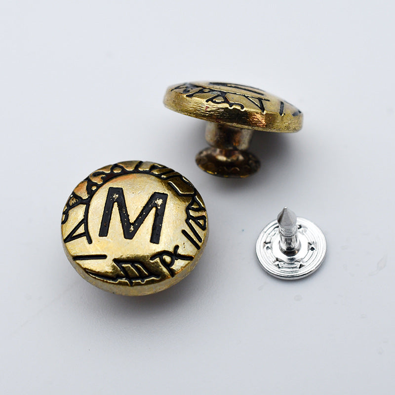 Round gold and silver metal shank stud buttons with letter M front and pointed post back
