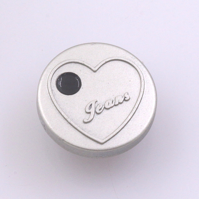 Silver 17mm heart stud button with 'Jeans' text, dark inset center