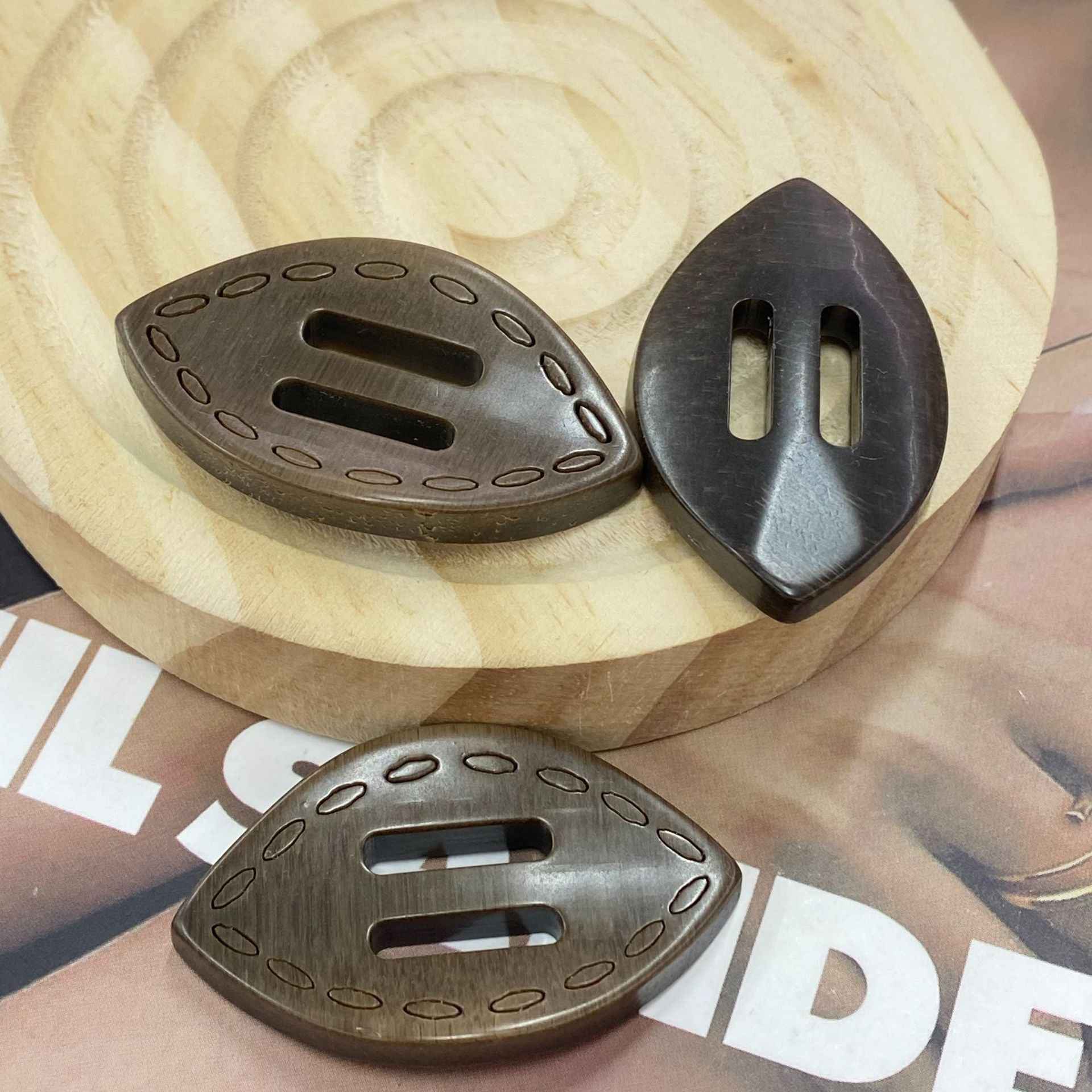 Dark gray oval resin 2-hole buckle buttons, oval slots with stitched border detail