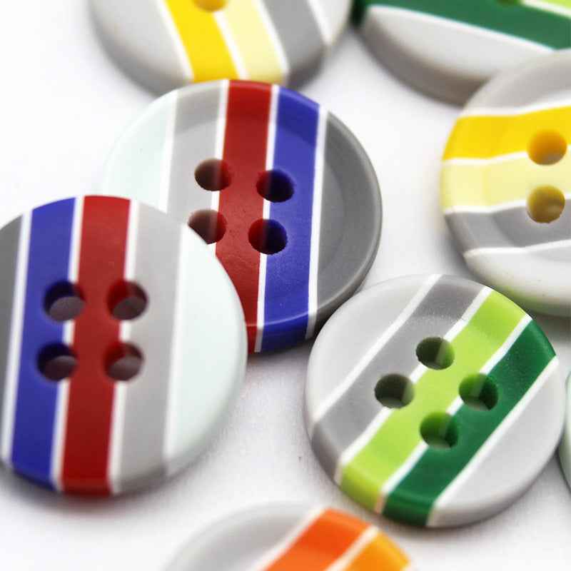 Mixed round resin buttons with striped designs; red, blue, and green sections with four holes