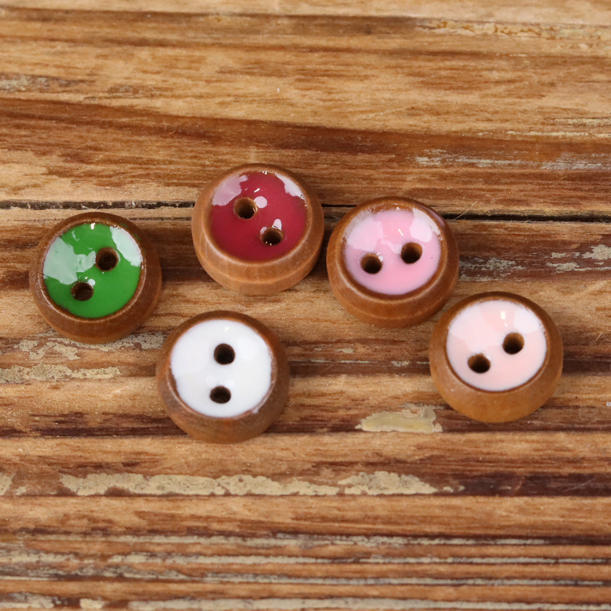 Round 2-hole wood shirt buttons with green, red, and pink fronts on display