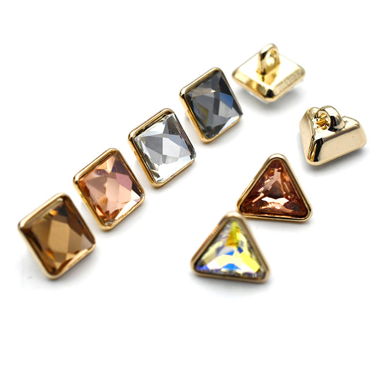 Gold-tone metal shank buttons with dark blue square and triangular glass cabochons
