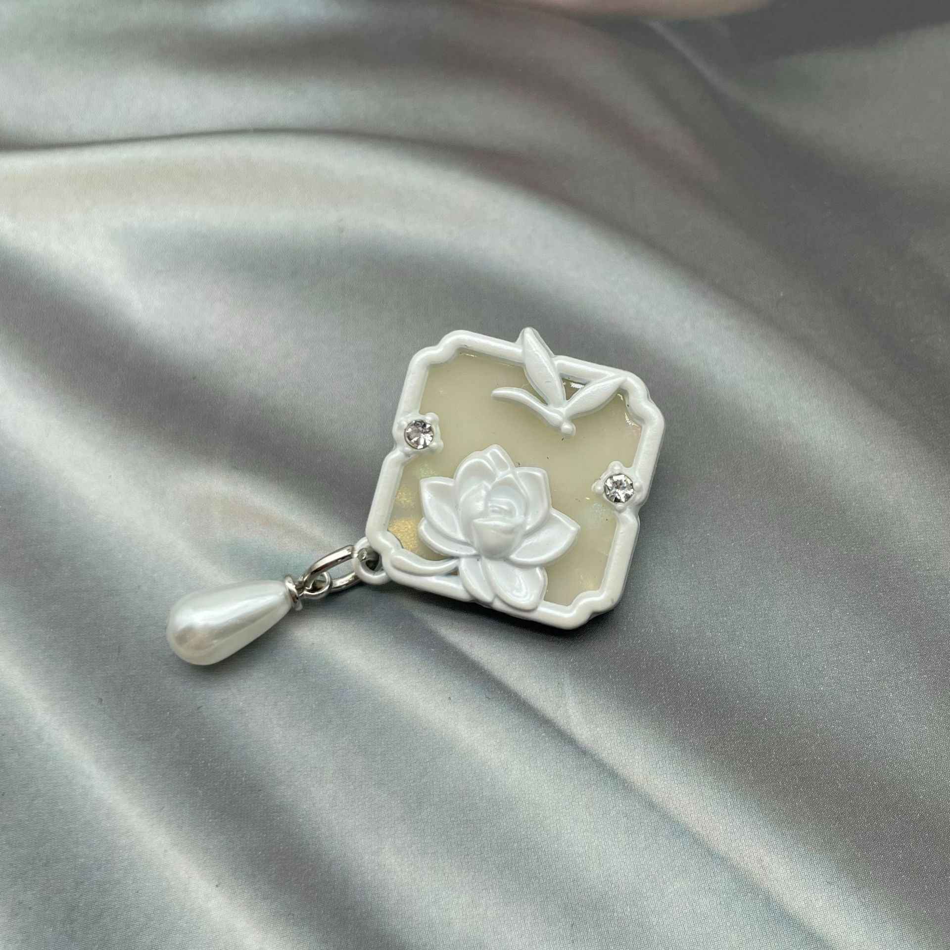White 1-inch metal sew-on button with lotus flower, dragonfly detail, crystal stones