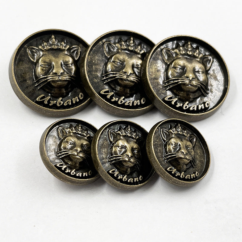 Set of bronze cat-head sewing buttons with crown, front views