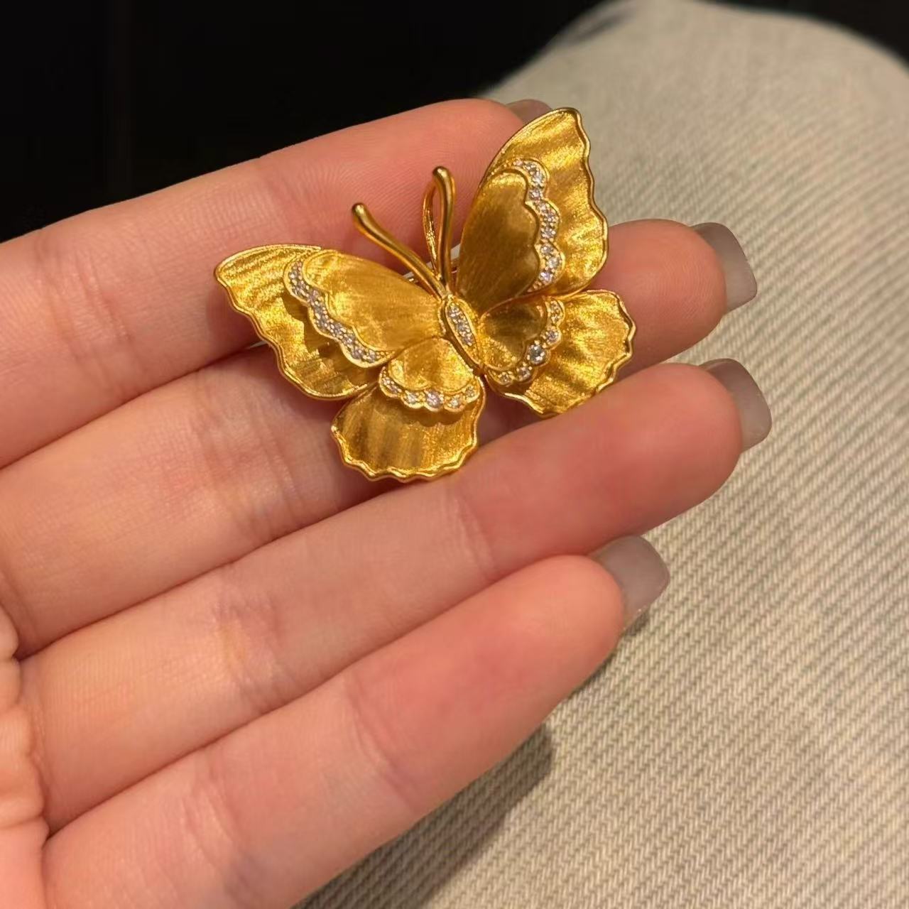 Gold butterfly brooch pin pair, brushed matte texture with faceted stone accents