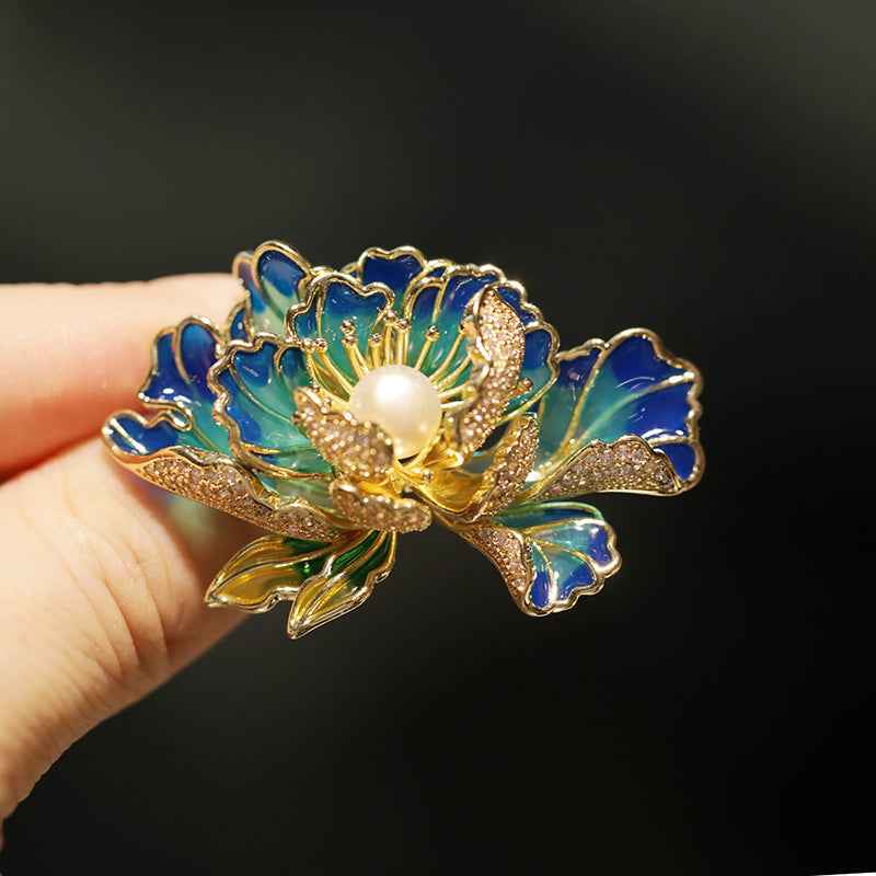 Blue enamel peony brooch with freshwater pearl at center and gold-tone beaded detailing