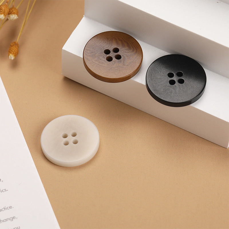 Set of flat 4-hole buttons in beige and dark tones, three buttons