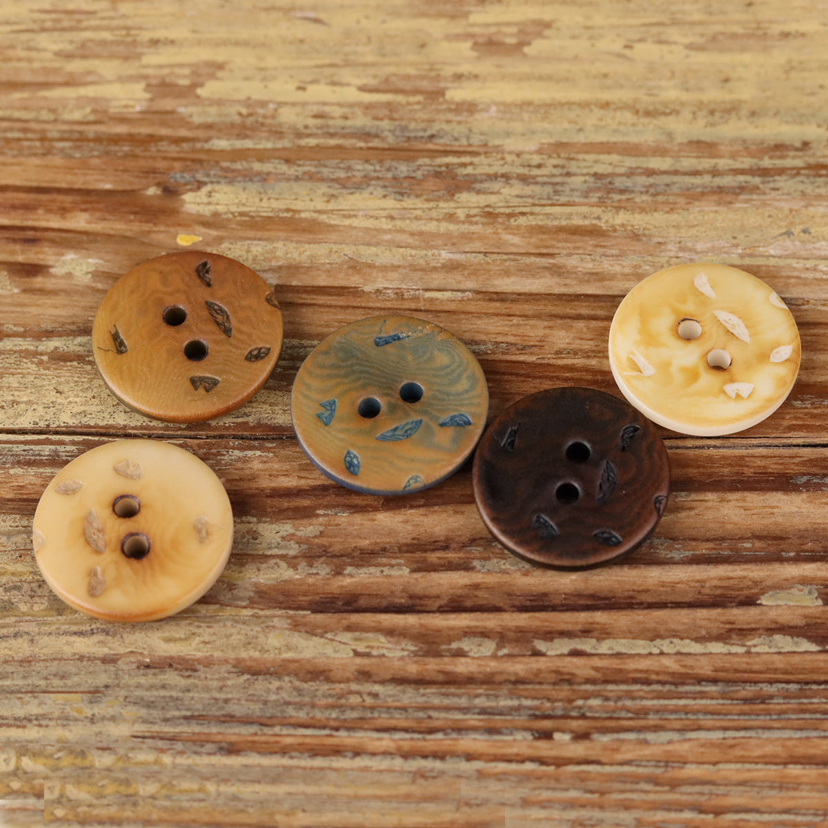 Round 2-hole buttons in golden beige and blue patterned shades, flat vintage style