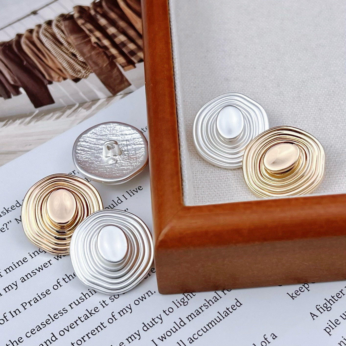 Silver 3D spiraled hat-shaped metal button with glossy oval center
