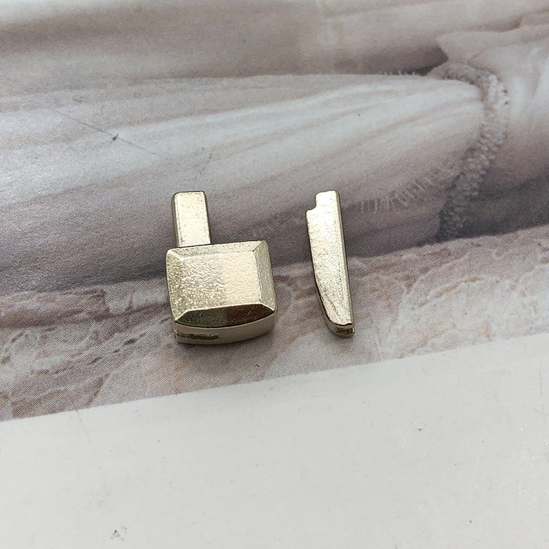 Gold-tone #5 zipper slider retainer with matching insertion pin tab