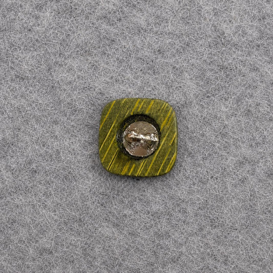 Green square shank button with visible metal shank plate and cross grooves