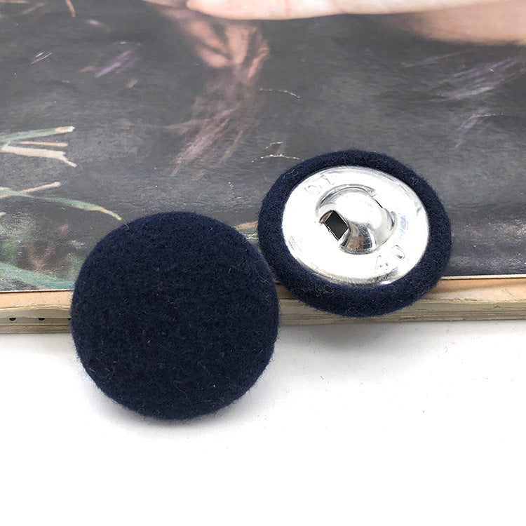 Two 28mm fabric-covered buttons: dark navy textile face with silver metal snap