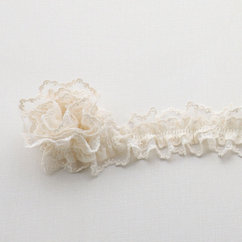 Beige double-layer lace ruffle trim with elastic, pleated rosette-like texture
