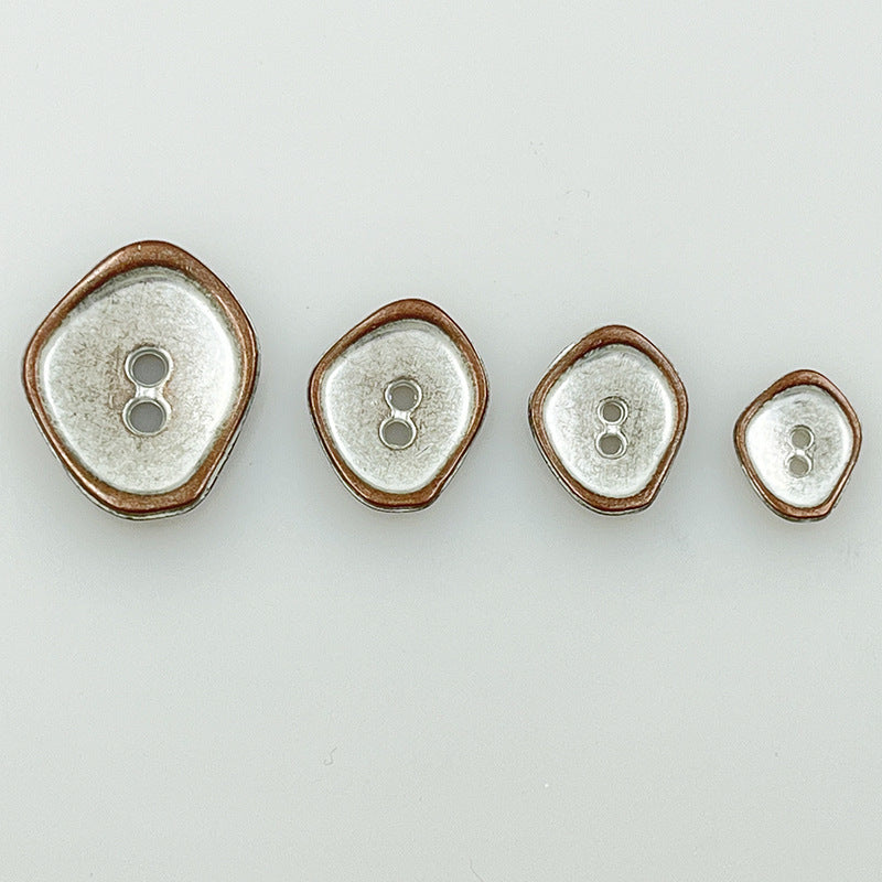 Two-hole metal buttons with irregular shape in silver finish, four sizes and brown outer rim