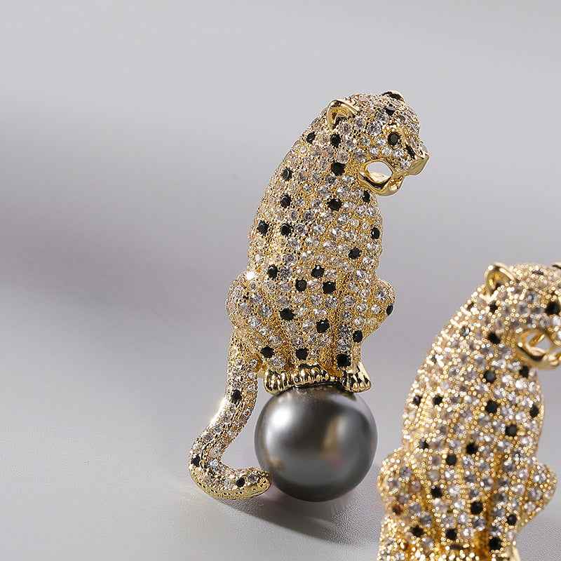 Copper zircon panther brooch with grey pearl drop and black spot accents