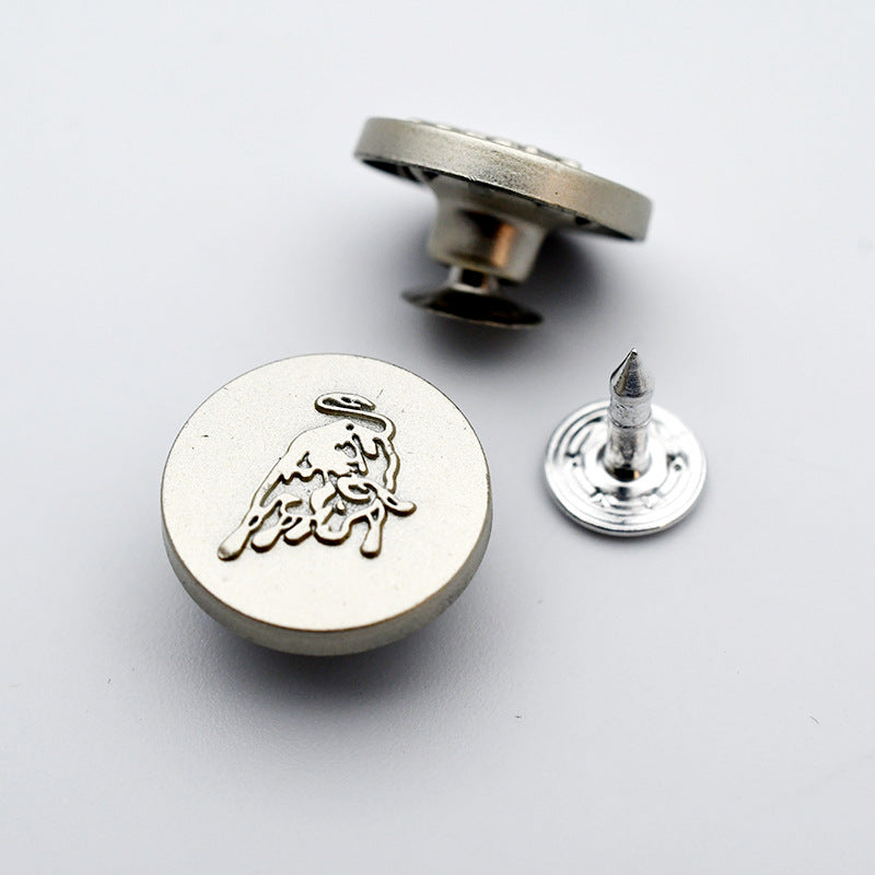 Round metal shank stud button with small animal motif on front and pointed post back