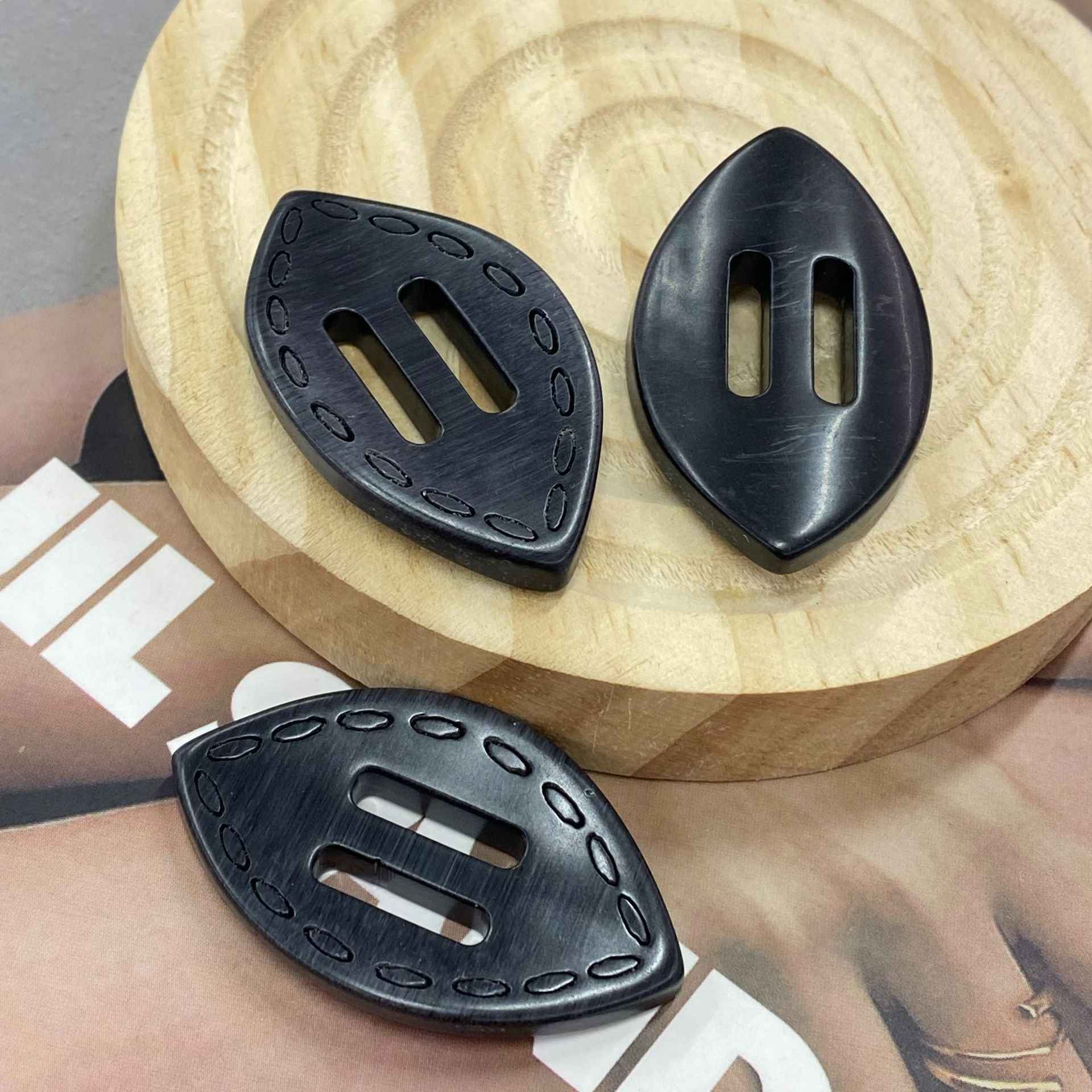 Black oval resin 2-hole buckle buttons, front with oval slots and smooth back