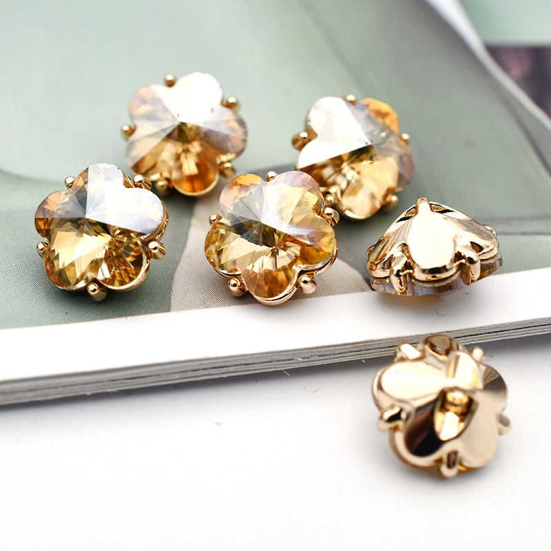 Small flower glass rhinestone shank buttons, light champagne flower faces with gold-tone settings and metal shanks
