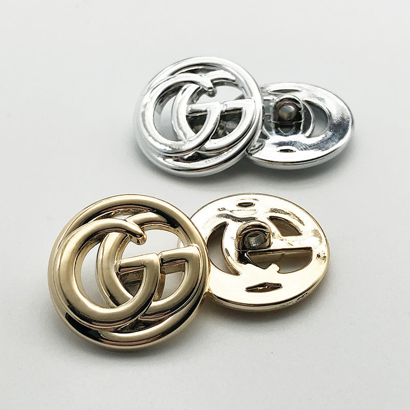 Silver double G shank plastic buttons with metal posts, front and shank shown