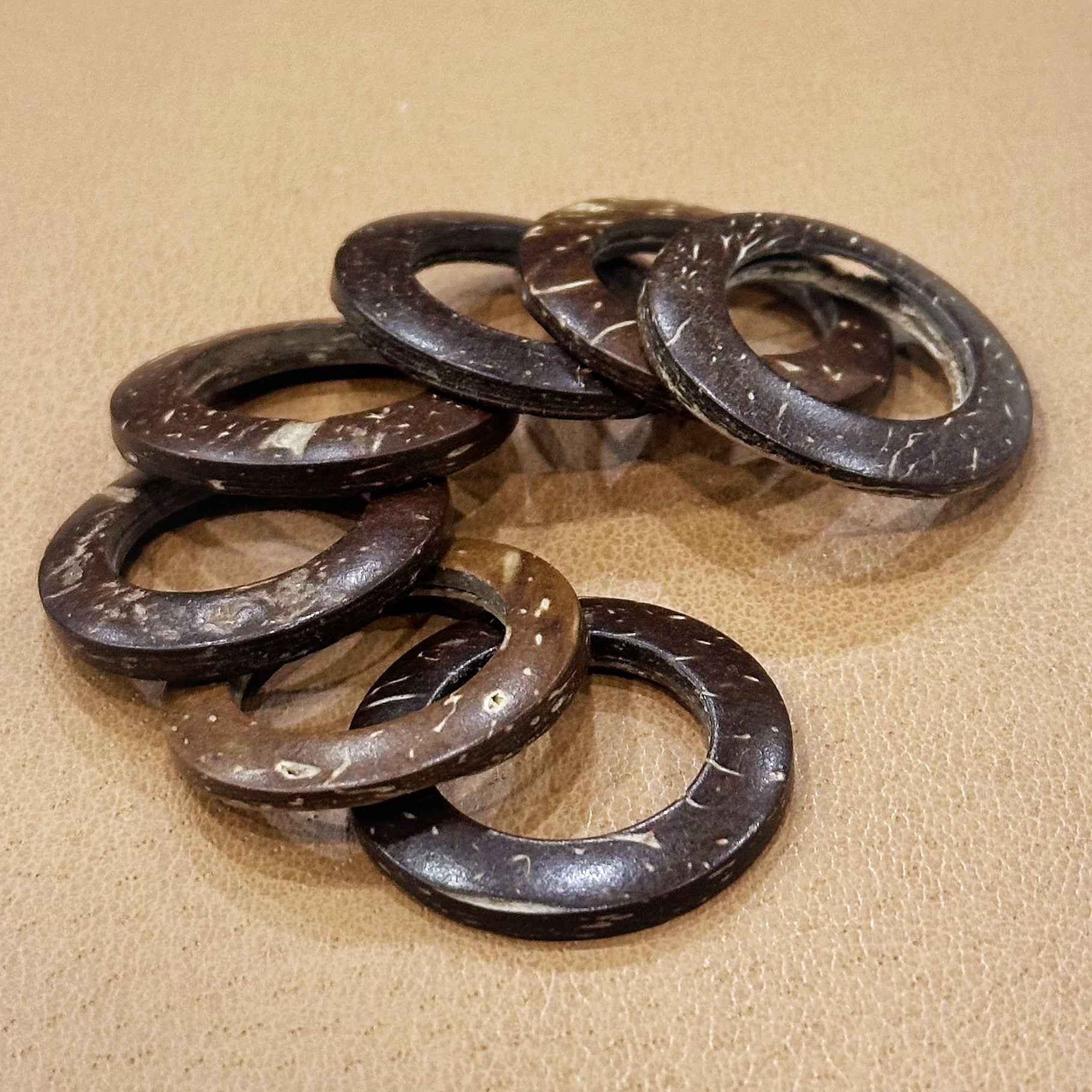 Natural coconut shell ring buttons, dark brown/black oval holes shown in close-up