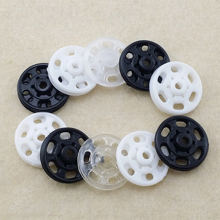 Invisible snap buttons in clear plastic with black and white bases, round set