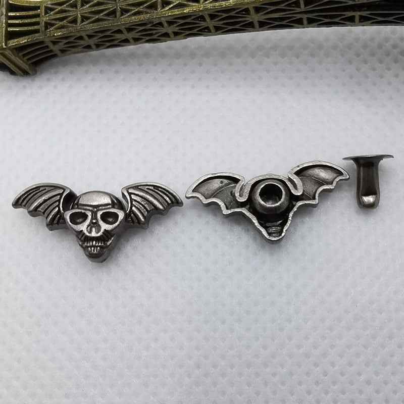 Skull rivet studs in silver tone, bat-wing style skull pieces and matching post