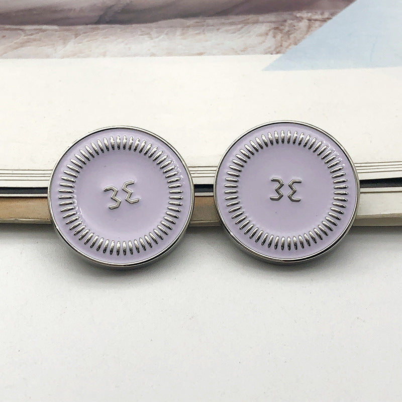 Style 1 round gold metal shank button, raised symbol on light face, 18mm