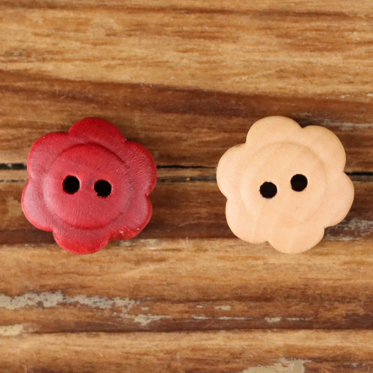 Two flower wood buttons: red and natural, each with two holes