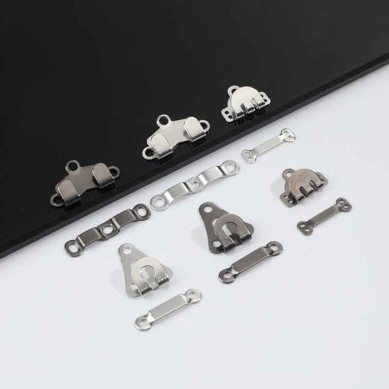 Metal trouser hook fasteners, silver and dark-tone clip parts shown together