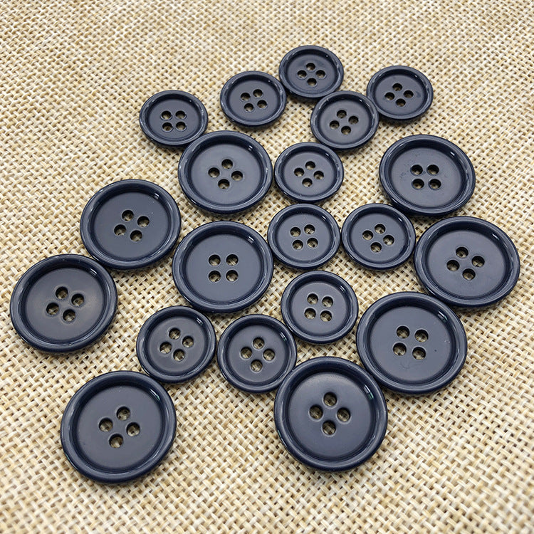 Navy round resin cuff buttons, 4-hole design; set of dark blue buttons on fabric