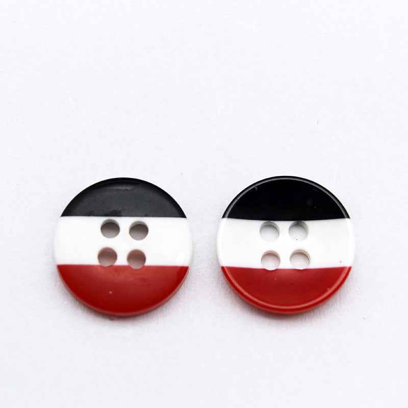 Round resin button with black top, white middle, and red bottom stripes; four holes.