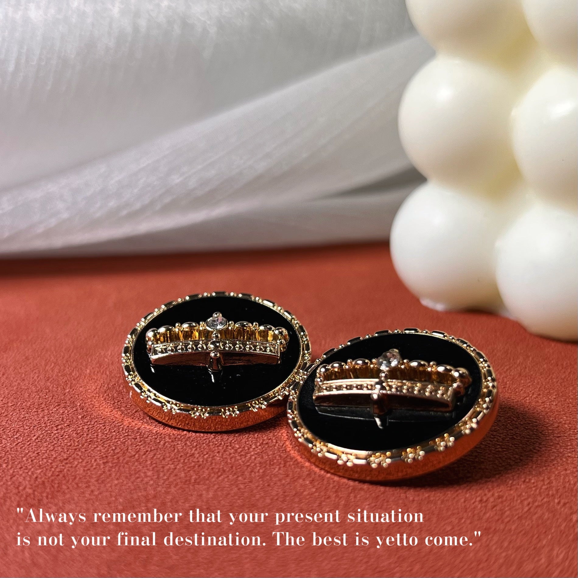 Two black crown glue buttons with gold-tone settings and central decorative crown