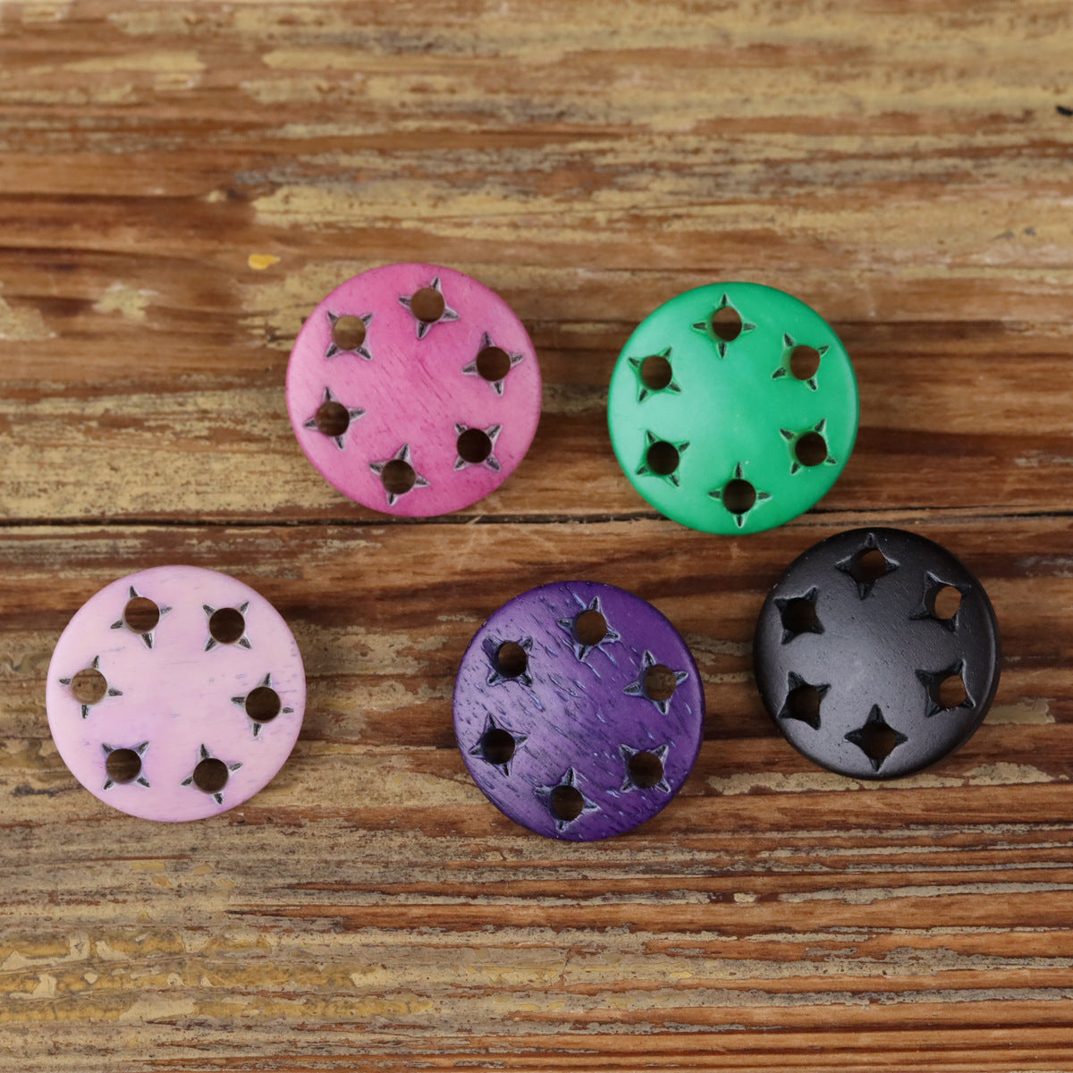 Star-cutout horn shank buttons in pink, green, purple, and black with metal holes