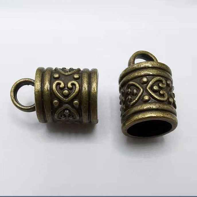 Bronze antique cylinder bell cord end cap with heart and scroll engravings, looped top