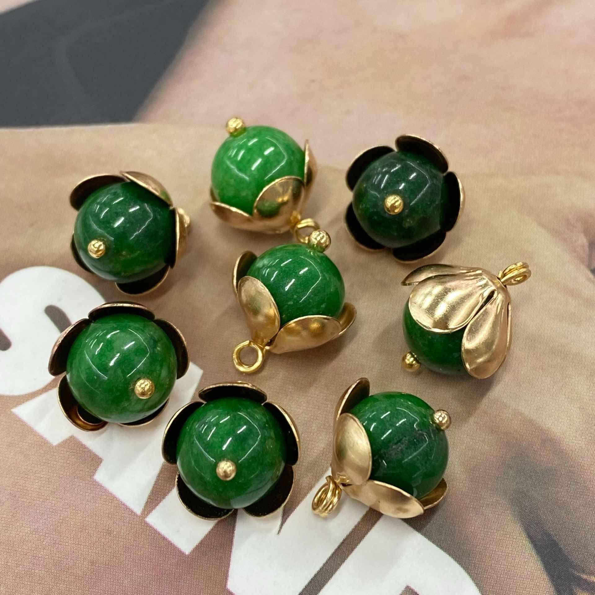 Assorted green jade-style 12mm buttons with gold-tone floral metal base settings