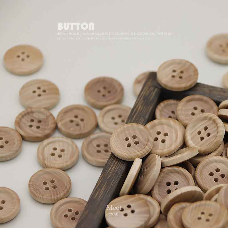 Pile of round natural wood 4-hole buttons in light tan with four openings