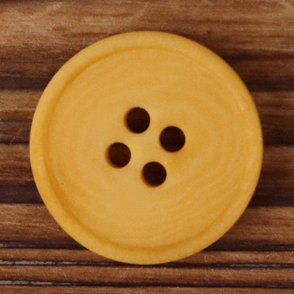 Yellow round 4-hole matte natural nut button with four dark holes
