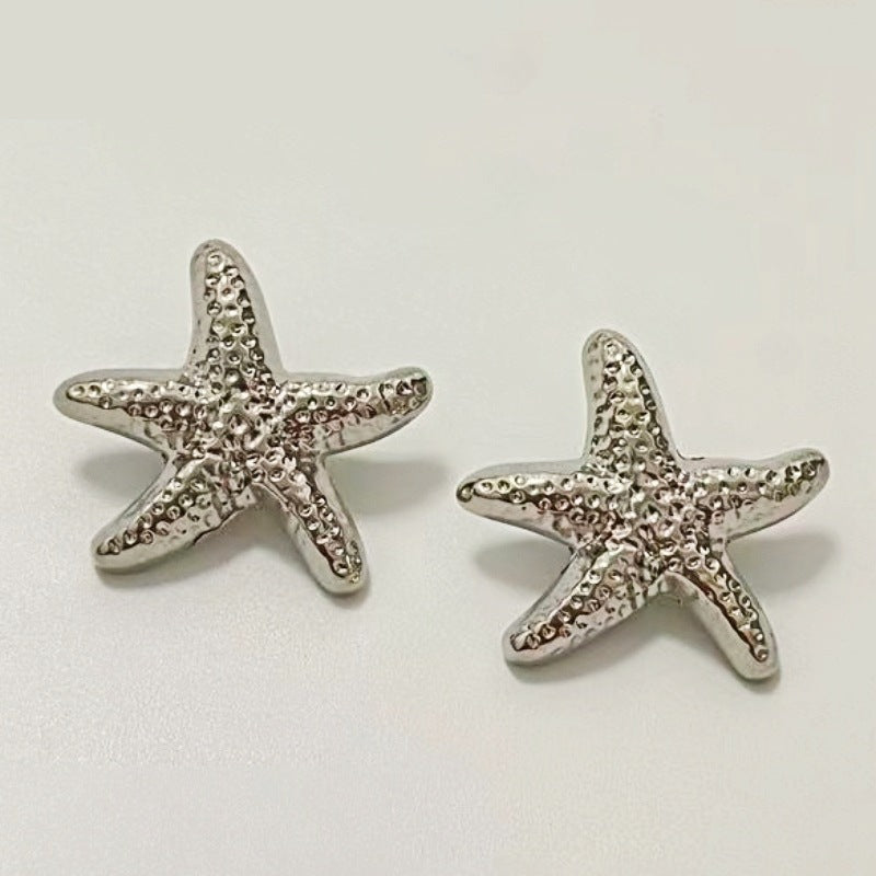 Silver starfish metal shank buttons, two sea-star designs with textured texture