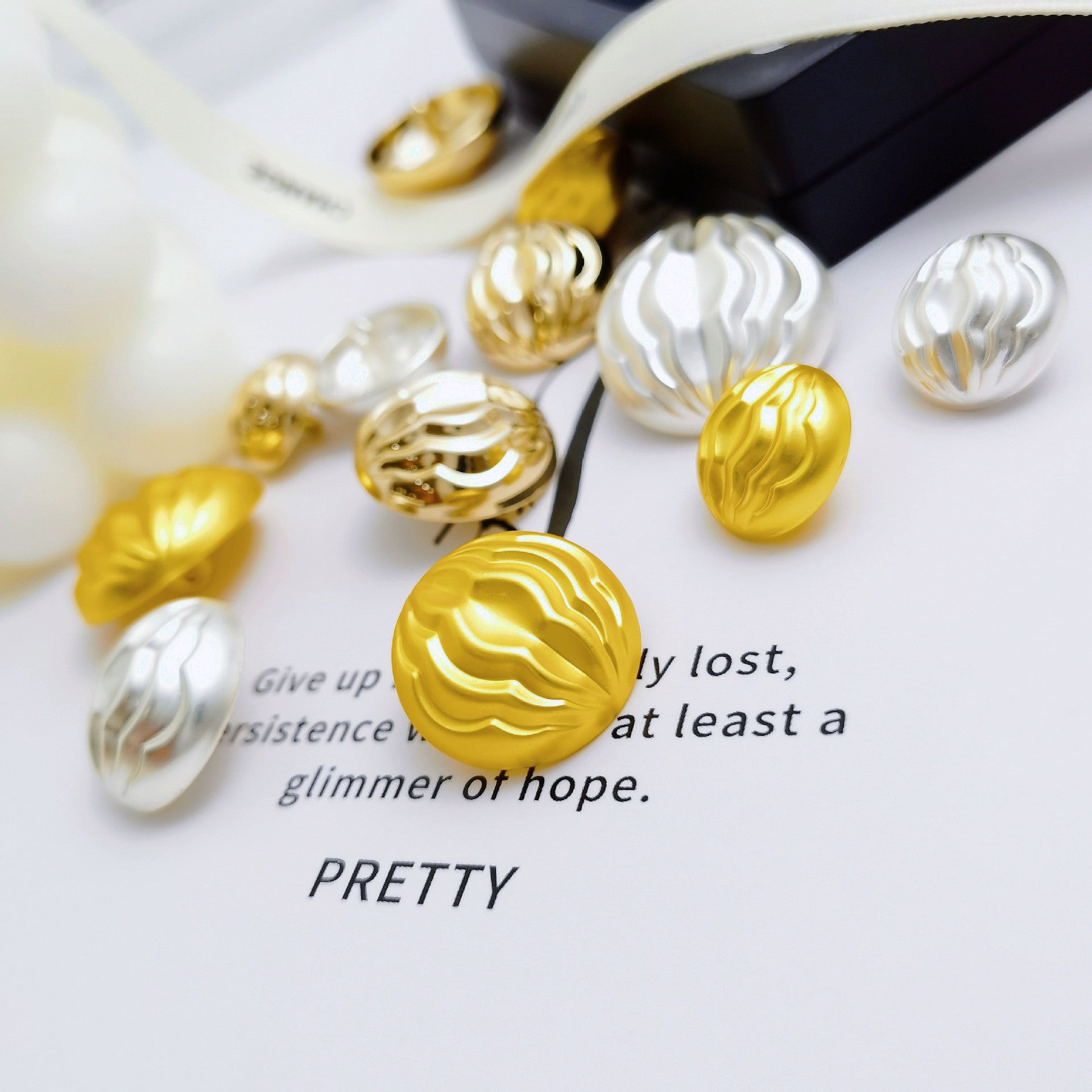 Pleated mushroom metal shank buttons, mixed gold and silver buttons shown