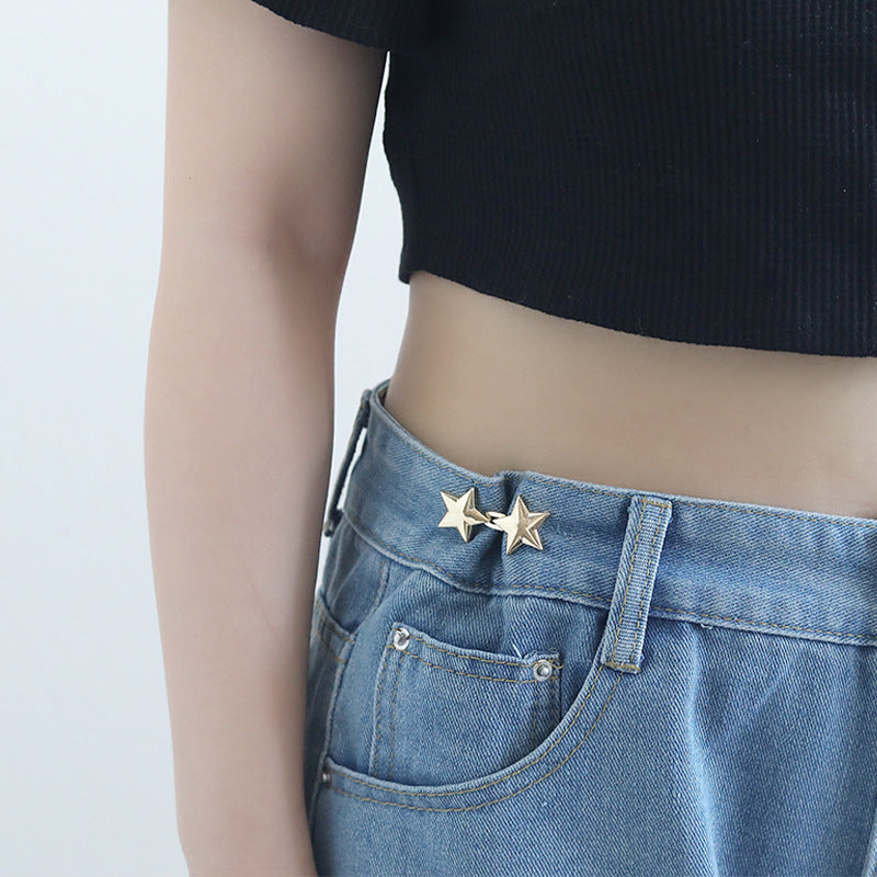 Star snap buttons on light blue denim waistband, gold and silver star studs