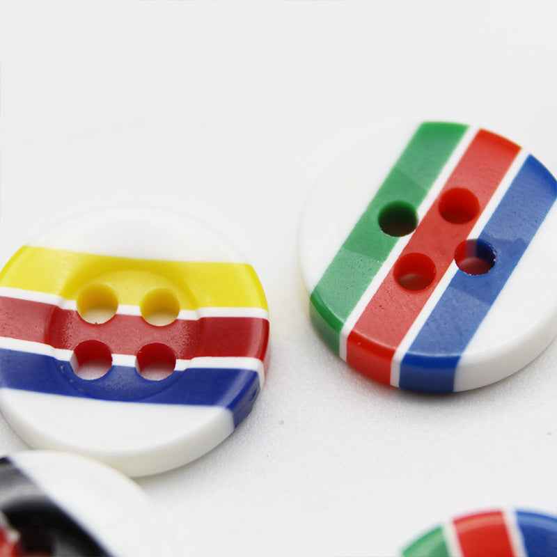 Round resin buttons with 4 holes, candy stripes: yellow, red, blue; close view